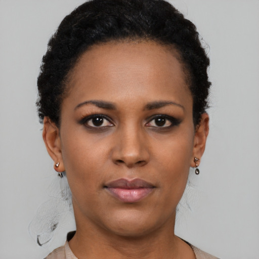 Joyful black young-adult female with short  brown hair and brown eyes