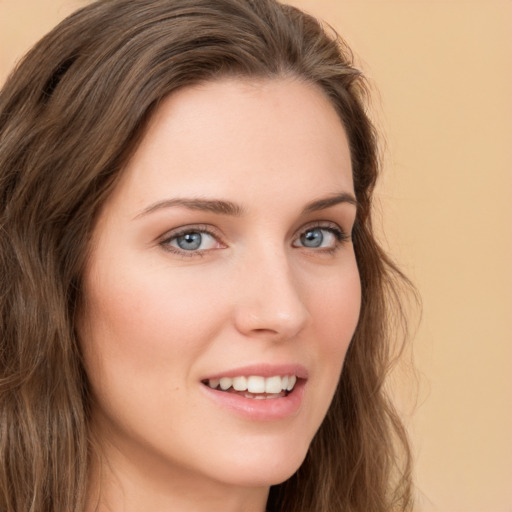 Joyful white young-adult female with long  brown hair and green eyes