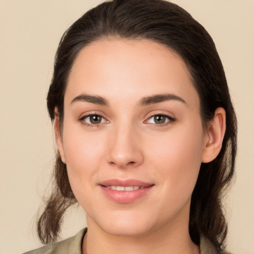 Joyful white young-adult female with medium  brown hair and brown eyes