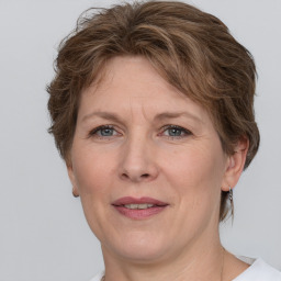 Joyful white adult female with medium  brown hair and grey eyes