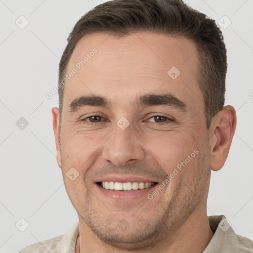 Joyful white adult male with short  brown hair and brown eyes