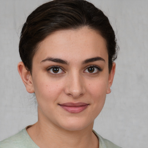 Joyful white young-adult female with medium  brown hair and brown eyes