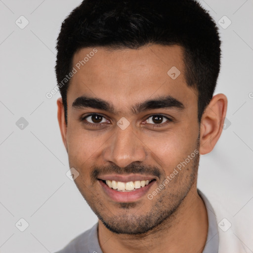 Joyful latino young-adult male with short  black hair and brown eyes