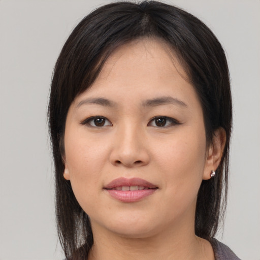 Joyful asian young-adult female with medium  brown hair and brown eyes