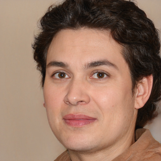 Joyful white adult male with medium  brown hair and brown eyes