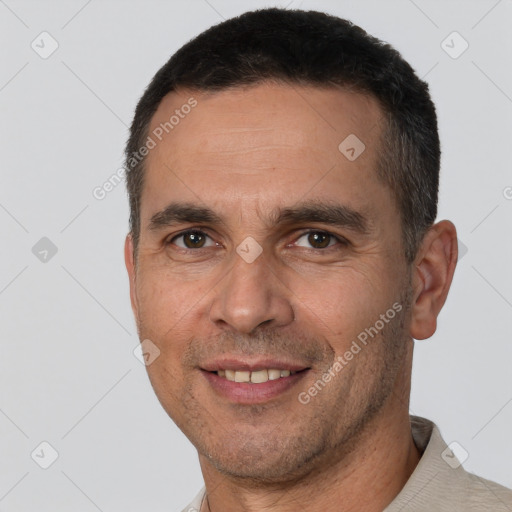 Joyful white adult male with short  brown hair and brown eyes