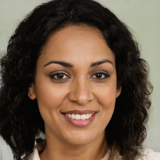 Joyful latino young-adult female with medium  brown hair and brown eyes