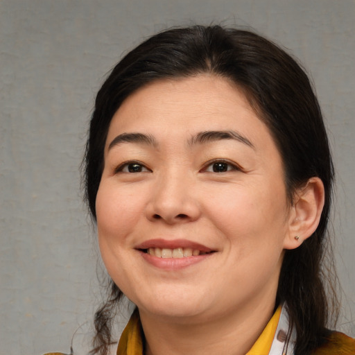 Joyful asian young-adult female with medium  brown hair and brown eyes