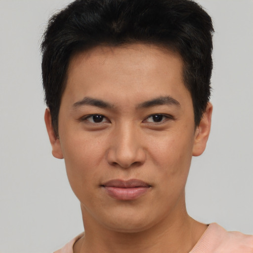 Joyful asian young-adult male with short  black hair and brown eyes