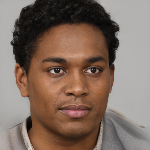 Neutral black young-adult male with short  black hair and brown eyes
