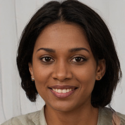 Joyful black young-adult female with medium  brown hair and brown eyes