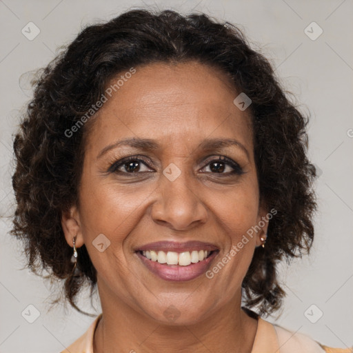 Joyful black adult female with medium  brown hair and brown eyes