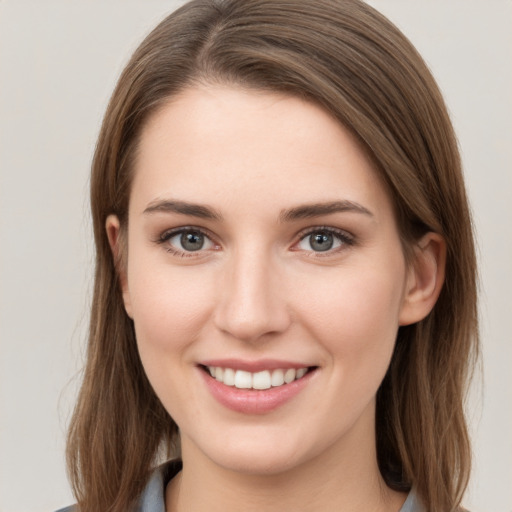 Joyful white young-adult female with long  brown hair and grey eyes