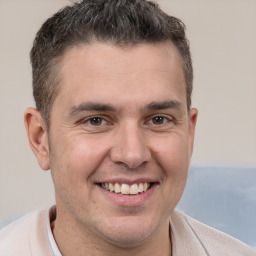 Joyful white adult male with short  brown hair and brown eyes