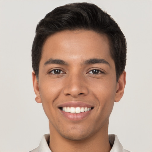 Joyful latino young-adult male with short  brown hair and brown eyes