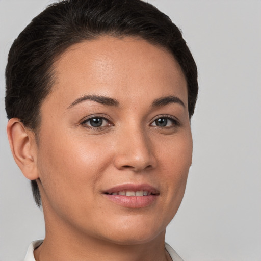 Joyful white young-adult female with short  brown hair and brown eyes