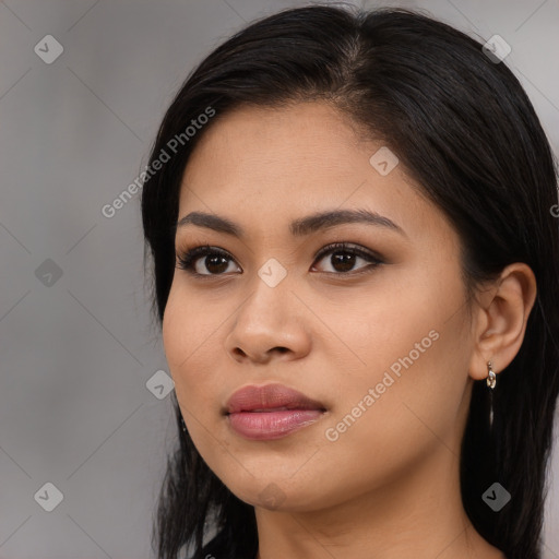 Joyful latino young-adult female with long  brown hair and brown eyes