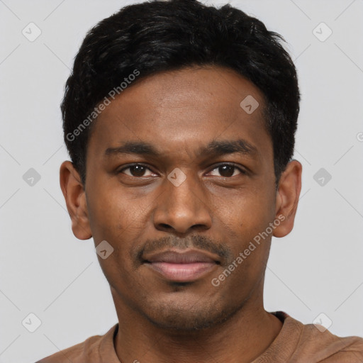 Joyful black young-adult male with short  black hair and brown eyes