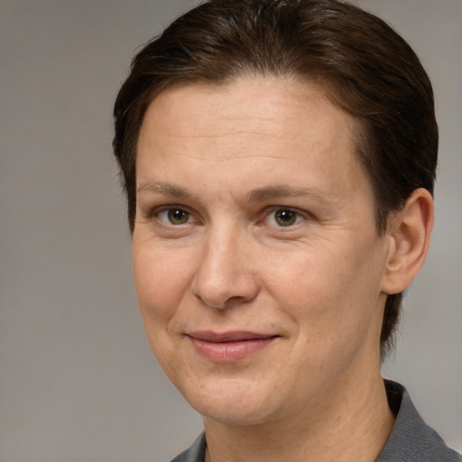 Joyful white adult female with short  brown hair and brown eyes