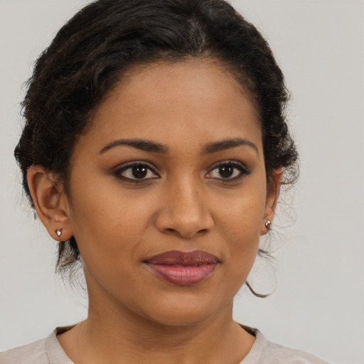 Joyful latino young-adult female with short  brown hair and brown eyes