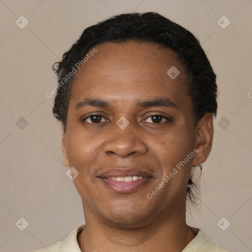 Joyful black adult male with short  black hair and brown eyes