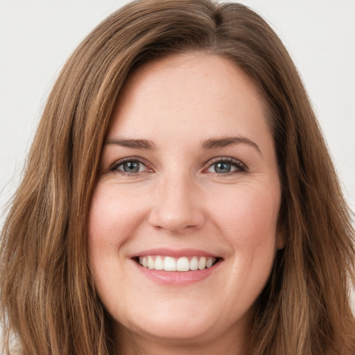 Joyful white young-adult female with long  brown hair and green eyes