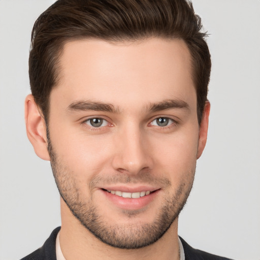 Joyful white young-adult male with short  brown hair and brown eyes