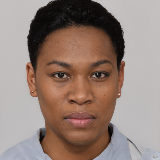 Joyful black young-adult female with short  black hair and brown eyes