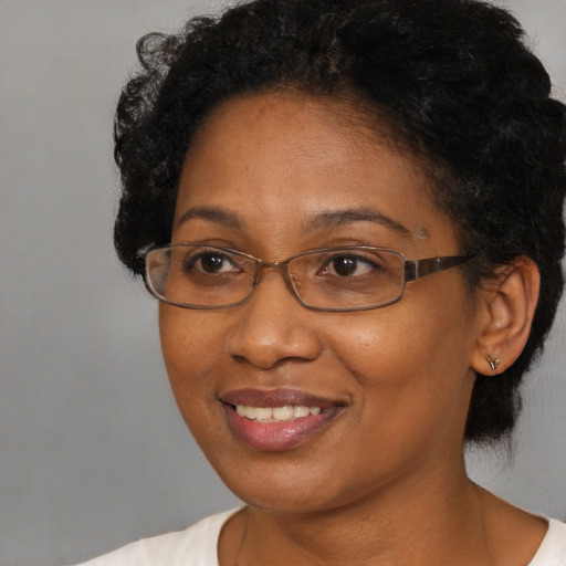 Joyful black adult female with short  brown hair and brown eyes