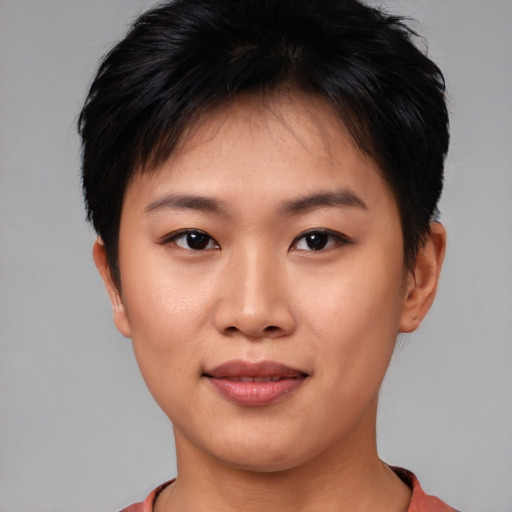 Joyful asian young-adult female with short  brown hair and brown eyes