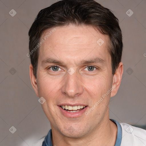 Joyful white adult male with short  brown hair and brown eyes