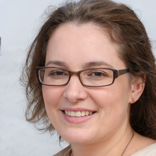 Joyful white adult female with medium  brown hair and grey eyes