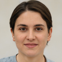 Joyful white young-adult female with medium  brown hair and brown eyes