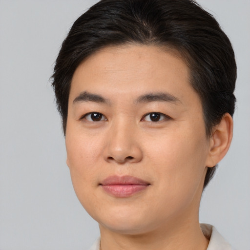 Joyful asian young-adult female with short  brown hair and brown eyes