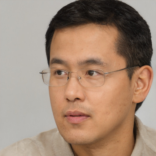 Neutral asian adult male with short  black hair and brown eyes