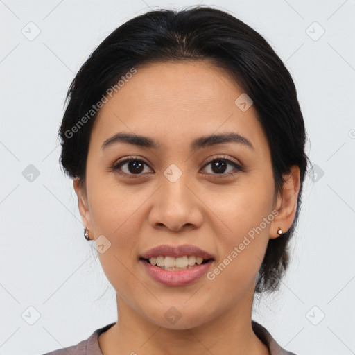 Joyful latino young-adult female with medium  brown hair and brown eyes