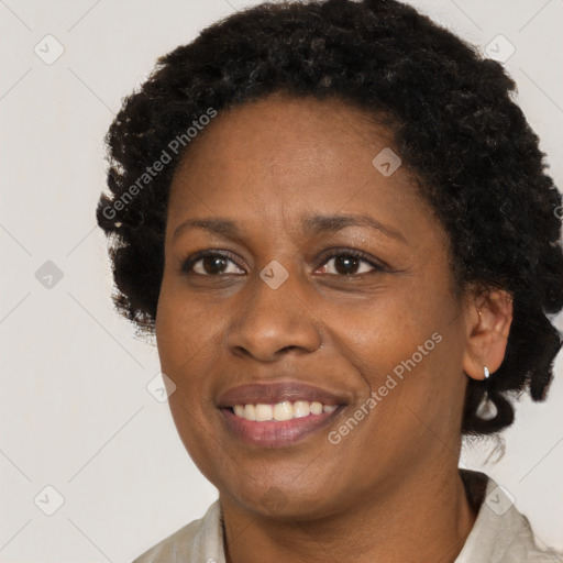 Joyful black adult female with short  brown hair and brown eyes