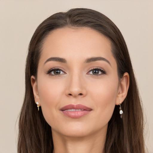 Joyful white young-adult female with long  brown hair and brown eyes