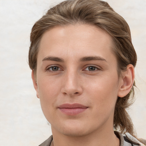 Joyful white young-adult female with short  brown hair and grey eyes