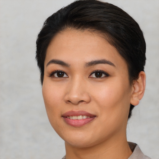Joyful asian young-adult female with short  black hair and brown eyes