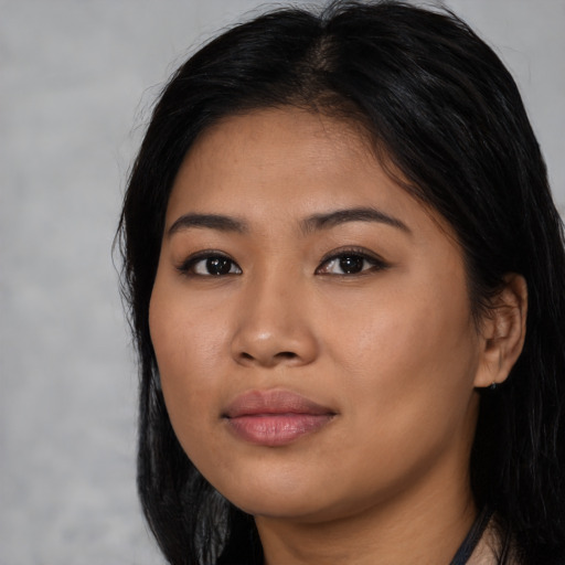 Joyful asian young-adult female with long  black hair and brown eyes