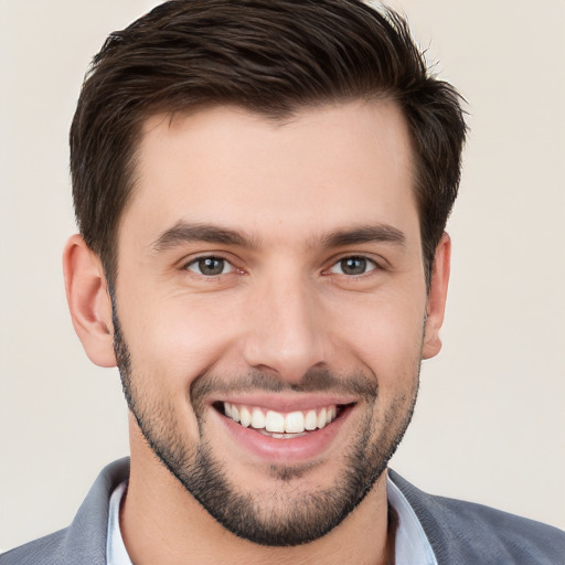 Joyful white young-adult male with short  brown hair and brown eyes