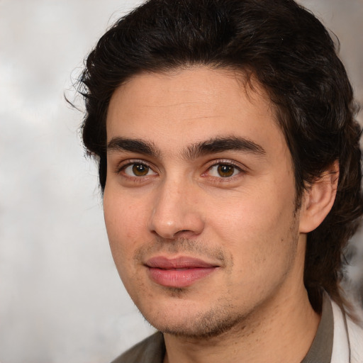 Joyful white young-adult male with medium  brown hair and brown eyes