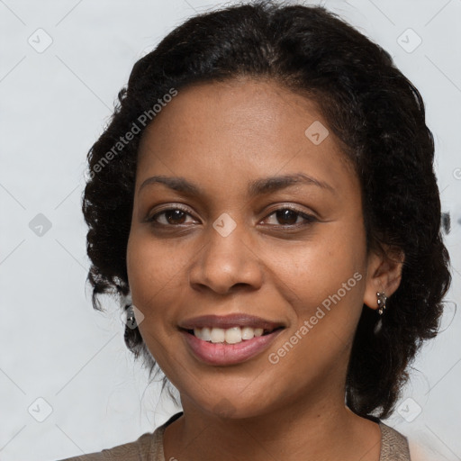 Joyful black young-adult female with long  brown hair and brown eyes