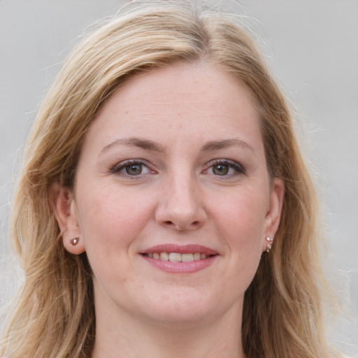 Joyful white young-adult female with long  brown hair and blue eyes