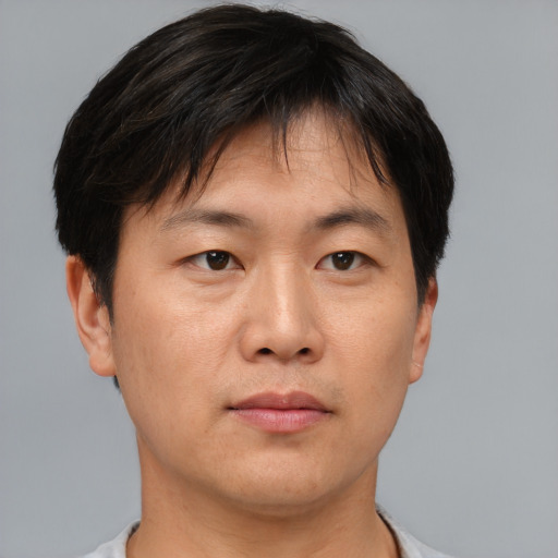Neutral asian adult male with short  brown hair and brown eyes
