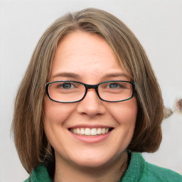 Joyful white young-adult female with medium  brown hair and green eyes