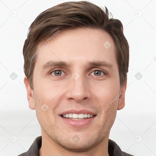 Joyful white young-adult male with short  brown hair and grey eyes