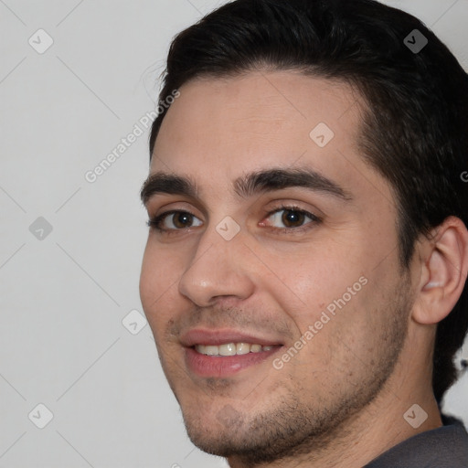 Joyful white young-adult male with short  black hair and brown eyes