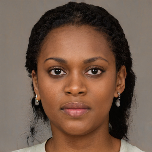 Neutral black young-adult female with medium  black hair and brown eyes